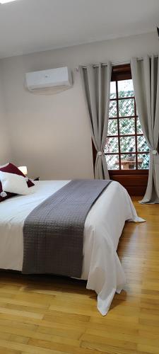 a bedroom with a large bed with a window at A&Bpikermistudios2 in Pikérmion