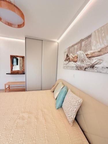 a bedroom with a bed and a painting on the wall at Villa Sunrice in Nea Peramos