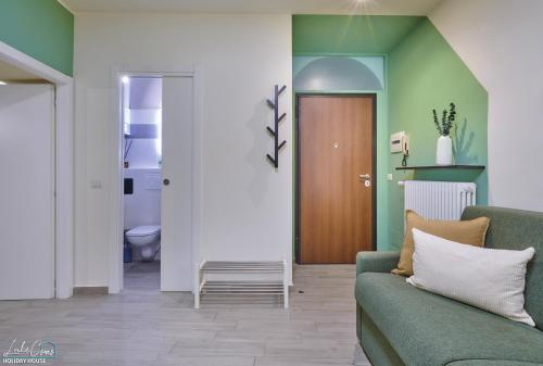 a living room with a couch and a door at Daniel House - Lake and ferry terminal 1 minute walk, in the heart of Bellano in Bellano