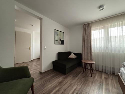 a living room with a couch and a chair at Hotel Krone Neuenburg in Neuenburg am Rhein