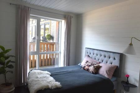 a bedroom with a bed with a large window at Torvika Hus in Isfjorden