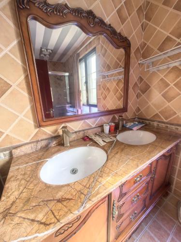 a bathroom with a sink and a mirror at Xiannv Mountain House in Chongming