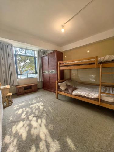 a bedroom with two bunk beds and a window at Xiannv Mountain House in Chongming