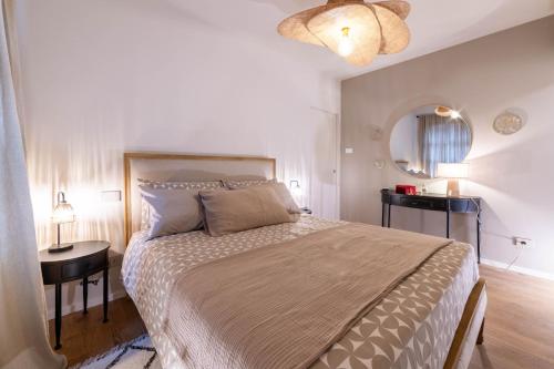 a bedroom with a large bed and a table at Ca' Mariet Langhe in Guarene