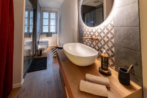 a bathroom with a large bowl sink and a mirror at Ca' Mariet Langhe in Guarene