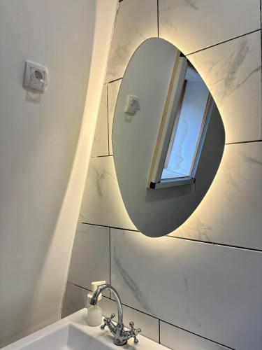 a bathroom with a mirror and a sink at Apartmani Terase in Konjska Reka