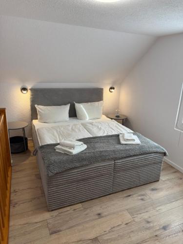 a bedroom with a large bed with two towels on it at Wittower Heide 40-1 in Glowe
