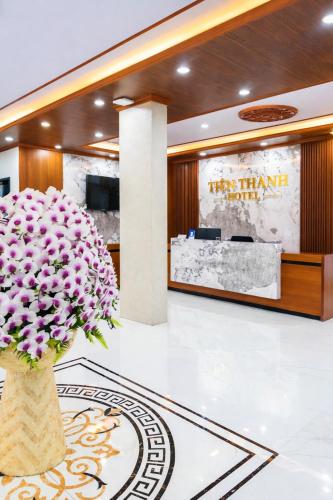 a vase filled with pink flowers in a lobby at Tiến Thành Hotel Nghệ An in Vinh