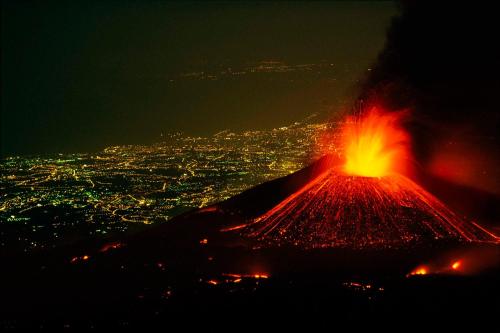 a volcano at night with a view of a city at B&B Villa San Leonardo in Mascali