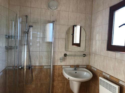 a bathroom with a shower and a toilet and a sink at Villa Rocky in Sozopol