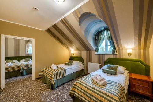 Кровать или кровати в номере Hotel Dwór Fijewo