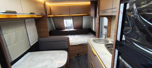a small room with a sink and a kitchen in an rv at Great Polonia Ustka in Ustka