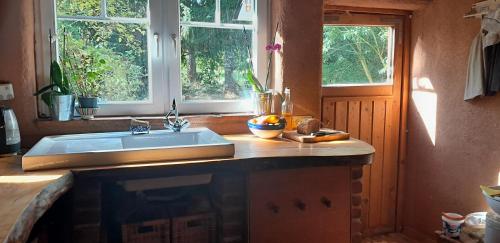 a kitchen with a sink and two windows at tausend plus eine nacht in Vöhl