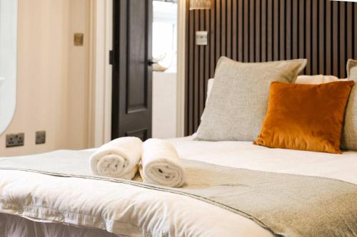a bedroom with a bed with towels on it at Lovely Studio Flat on Bath Road - Flat 10 in Bristol