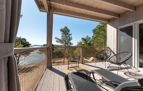 a screened in porch with chairs and a large window at Mobile home Azzurro in Drage