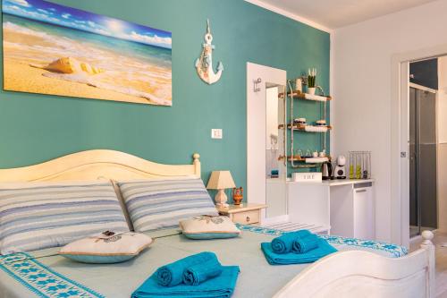 a bedroom with a bed with blue walls at Affittacamere LiKele in Castelsardo