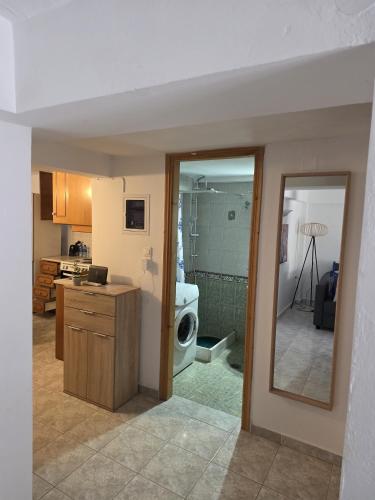 a kitchen with a sink and a washing machine at Jim's House in Káspakas