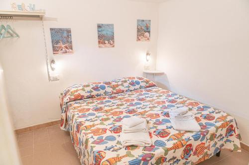 a bedroom with a bed with towels on it at La Casina Del Campese in Campese
