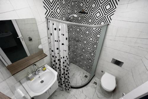 a bathroom with a shower and a toilet and a sink at dupleqs batumi daRia in Angisa