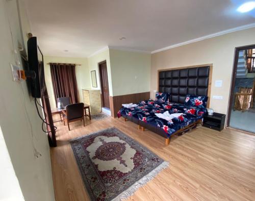 a living room with a bed and a television at Hotel castle rock in Pahalgām