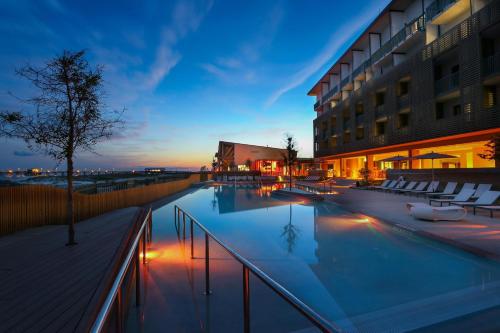 a swimming pool in front of a building at The Lodge at Gulf State Park, A Hilton Hotel in Gulf Shores