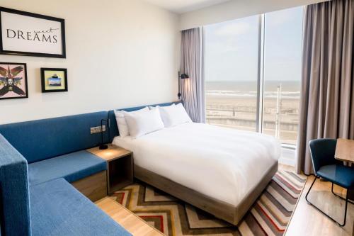 a hotel room with a bed and a couch at Hampton By Hilton Blackpool in Blackpool