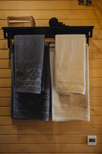 two towels are hanging on a wooden table at Putyscha house in Tukhlya