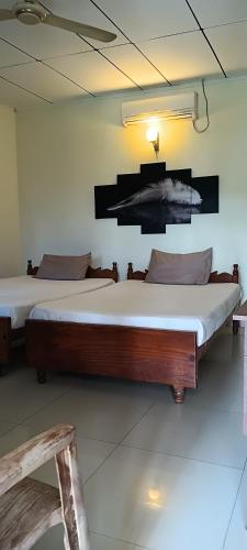 a large bed in a room with at Hansika Guest Inn in Buttala