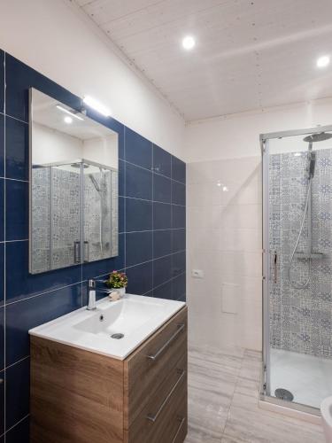 a bathroom with a sink and a shower at Agorà di Favignana - Affittacamere Piazza Madrice in Favignana