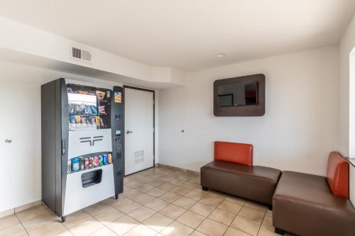 a living room with a couch and a refrigerator at Motel 6-San Antonio, TX - South IH-10 East in San Antonio