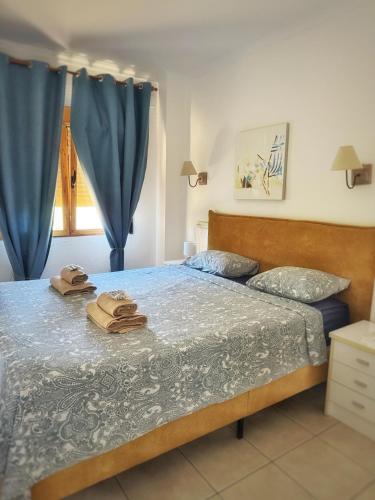 a bedroom with a bed with two towels on it at Bungavilla House in La Isla in Jávea