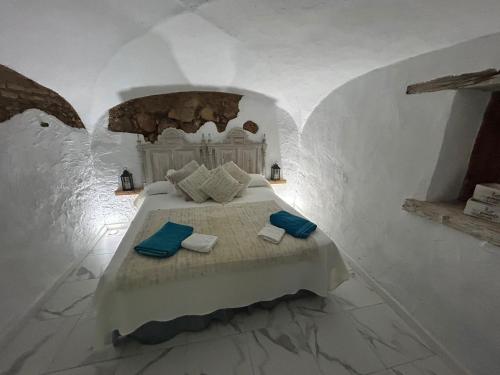 a bedroom with a bed with blue pillows on it at Almodovar alojamientos 1 in Almodóvar del Río
