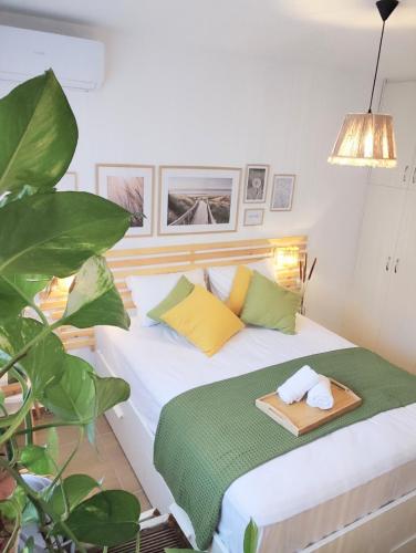 a bedroom with a bed with a tray on it at Harmony garden house in Porto Rafti