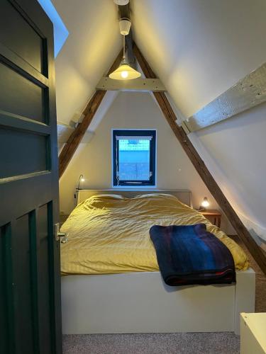 a bedroom with a bed in the attic at Appartement city center in Harlingen