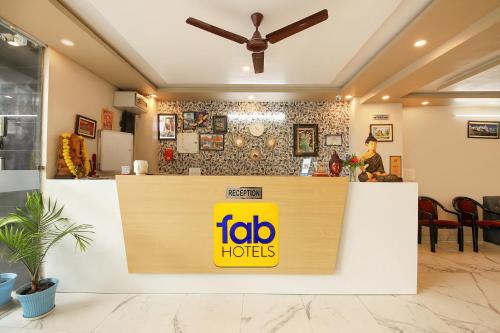 a fast food restaurant with a yellow sign on a counter at FabHotel Rudra in Dehradun