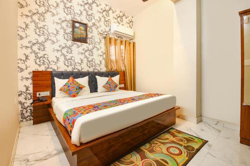 a bedroom with a large bed in a room at FabHotel Rudra in Dehradun