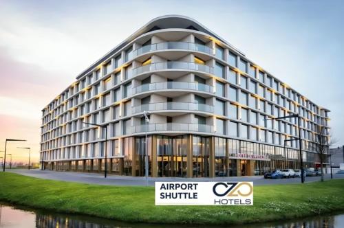 an apartment building with a sign in front of it at OZO Hotels De President Amsterdam Schiphol Airport in Hoofddorp