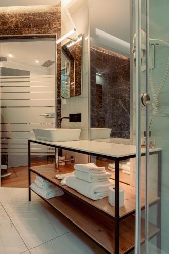 a bathroom with a sink and a counter with towels at GRANDI 32 Boutique Residence in Segrate