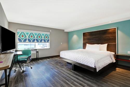 a hotel room with a bed and a desk and a computer at Tru By Hilton Edmonton Windermere in Edmonton