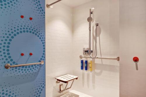 a bathroom with a shower with a toilet in it at Tru By Hilton Edmonton Windermere in Edmonton