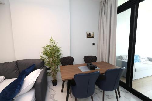 a living room with a table and a couch at Central Stay 1 Bed Junior near Cleveland and Abu Dhabi Mall in Abu Dhabi