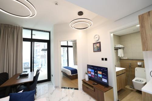 a hotel room with a desk and a bedroom at Central Stay 1 Bed Junior near Cleveland and Abu Dhabi Mall in Abu Dhabi