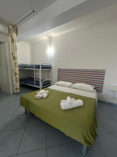a bedroom with a bed with two towels on it at Capo Scalambri in Santa Croce Camerina