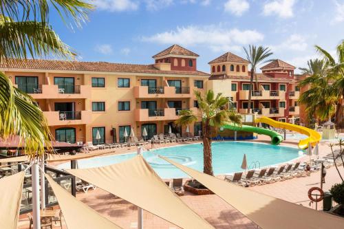 a pool at the resort with a slide at BLUESEA Aloe Corralejo in Corralejo
