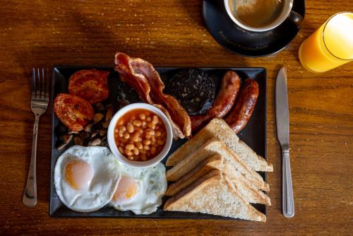 a plate of breakfast food with eggs bacon beans and toast at The bucks head in Church Stretton