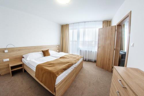 a bedroom with a large bed in a room at Alexandra Šport Hotel in Púchov