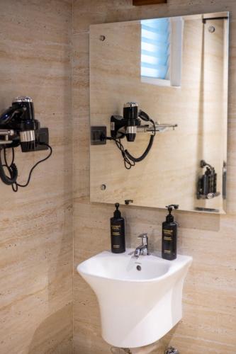 a bathroom with a sink and a mirror at Dreamscape Banjara Hills in Hyderabad