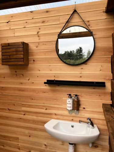a bathroom with a mirror and a sink at Glamping Tent - Bell Tent in Brackley