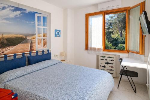 a bedroom with a blue bed and a window at Affitta Camere di Berenice in Porto Azzurro