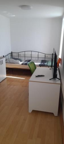 a room with a bed and a desk with a computer at Ela Gar 5 WG Zimmer in Garsten